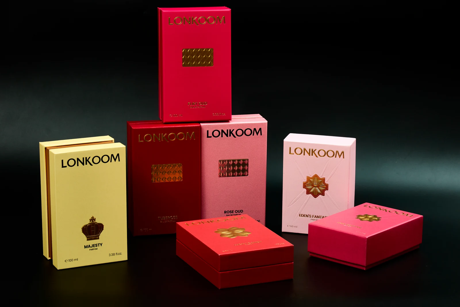 Red, pink and gold fragrance boxes arranged as a collection