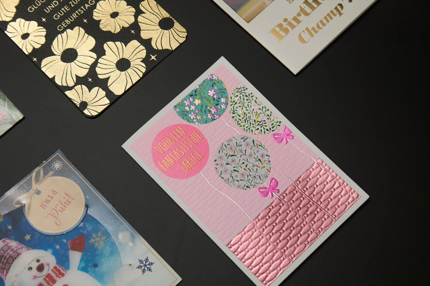 Close-up of a pink greeting card with balloon artwork